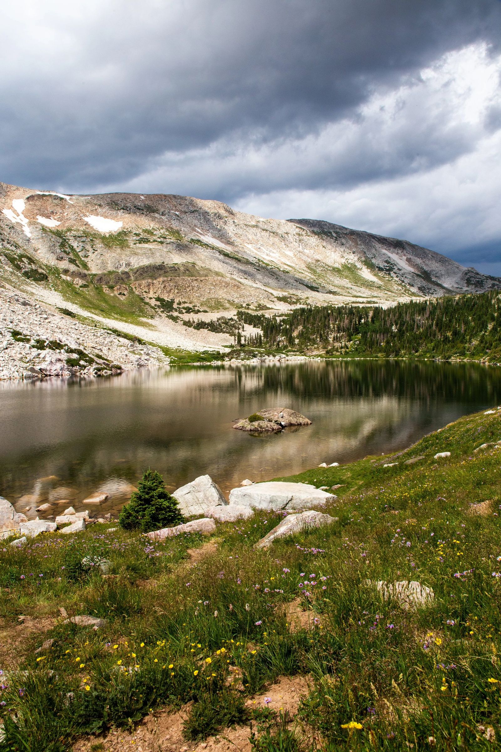An alpine lake beneath rugged mountains